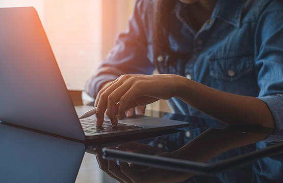 Woman On Her Computer Current Scams 555X360