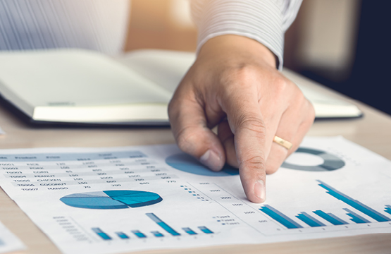 A man pointing to financial figures on a sheet of paper_Intro to Mutual Funds_____555X360