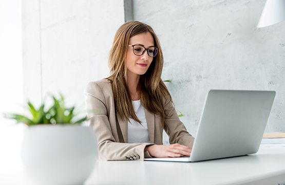 Woman Typing On A Computer Protect Yourself From Fraud 555X360